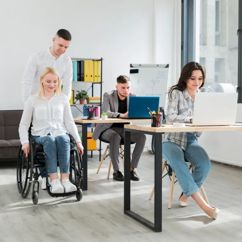 Office team at work, including a colleague using a wheelchair